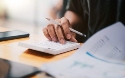 Close up hand of accountant working with calculator for business and financial expense.
